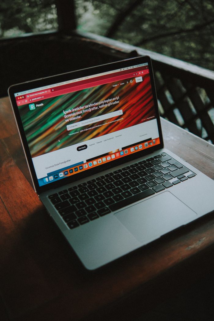 Overcoming Challenges Lessons Every Entrepreneur Must Learn A close-up view of a laptop with a website open, placed on a wooden table near a window.